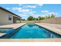 Inviting pool with travertine deck and privacy fence is perfect for outdoor relaxation and entertaining at 1740 Standing Rock Cir, Oakland, FL 34787