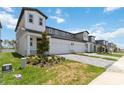 Exterior of a townhome with two-car garage and landscaped front yard at 1797 Archer Dr, Minneola, FL 34715