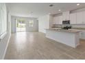 Bright open-concept kitchen and living space with tiled floors and ample natural light at 1797 Archer Dr, Minneola, FL 34715