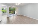 Bright bedroom with sliding glass doors leading to an outdoor patio at 1908 Lake Atriums Cir # 3, Orlando, FL 32839