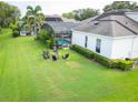 Spacious backyard featuring a well-maintained lawn and a fire pit with seating near the main house at 1932 Reed Hill Dr, Windermere, FL 34786
