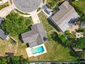 An aerial view showcasing the home, pool, and surrounding landscaped yard in a quiet neighborhood at 217 Melissa Ct, Sanford, FL 32773