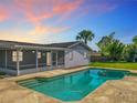 Backyard featuring a sparkling pool and screened-in patio, perfect for outdoor entertaining at 217 Melissa Ct, Sanford, FL 32773