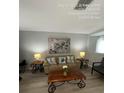 Cozy living room featuring a comfortable sofa, decorative pillows, and stylish accent tables with lamps at 226 Canna Dr, Davenport, FL 33897