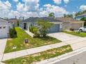 Attractive single-story home featuring a manicured lawn and a two-car garage, set in a tranquil residential neighborhood at 236 Miles Ct, Davenport, FL 33837