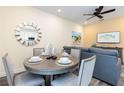 Cozy dining area featuring a round table set for four, next to the living area at 2923 Castaway Ln, Kissimmee, FL 34747