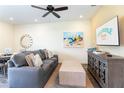 Comfortable living room with a gray sofa, modern decor, and a Margaritaville Resort themed television at 2923 Castaway Ln, Kissimmee, FL 34747