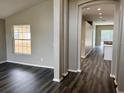 Spacious living area with gray wood-look flooring and an open archway at 307 Dalton Ct, Davenport, FL 33897