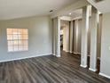 Open-concept living room featuring gray wood-look floors and ample natural light at 307 Dalton Ct, Davenport, FL 33897