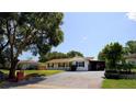 Charming single-story home featuring a well-maintained lawn and a spacious driveway, perfect for a growing Gathering at 3223 Dragoon Pl, Orlando, FL 32818