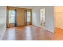 Spacious bedroom with wood floors and large windows and an ensuite bathroom with shower and closet at 324 Sir Lawrence Dr, Sanford, FL 32773