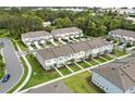 Neighborhood aerial view showcasing modern townhomes, green spaces, and well-manicured lawns at 3256 Merton Aly, Orlando, FL 32808