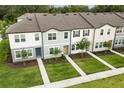 Aerial view of modern townhomes featuring well-kept lawns and inviting entryways at 3256 Merton Aly, Orlando, FL 32808