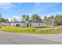 Charming corner lot single-story home with a modern design, black trim, and a two-car garage at 3749 Sw 131St St, Ocala, FL 34473