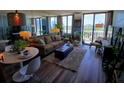 Sun-filled living room featuring hardwood floors, large windows with a view, and comfortable seating at 400 E Colonial Dr # 910, Orlando, FL 32803