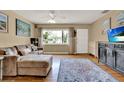 Inviting living room featuring hardwood floors, and ample natural light from a large window at 4015 Ibis Dr, Orlando, FL 32803