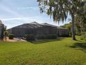 Expansive backyard featuring a screened lanai perfect for outdoor living and entertaining at 4351 Winding Oaks Cir, Mulberry, FL 33860