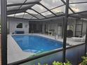 Sparkling screened-in pool with ample deck space, offering a private oasis for relaxation and fun at 4351 Winding Oaks Cir, Mulberry, FL 33860