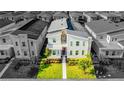 An aerial view of a modern townhouse with well-manicured lawn, and dedicated parking spaces at 4530 Narrative Ln, Kissimmee, FL 34746