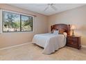 Cozy bedroom with neutral walls, tile flooring, and a view of the outdoors at 5083 Eaglesmere Dr # A12, Orlando, FL 32819