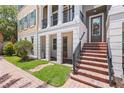 Charming townhome exterior showcasing brick steps, a welcoming entrance, and well-maintained landscaping at 524 Lanark Ct, Orlando, FL 32806