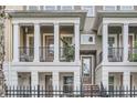 Attractive townhome facade featuring a covered balcony with black railings, a cozy seating area, and a welcoming entrance at 524 Lanark Ct, Orlando, FL 32806