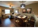 Open-concept living area with dining, comfy sofas, dark wood floors and natural light at 5370 Diplomat Ct # 107, Kissimmee, FL 34746