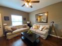 Relaxing living room featuring cozy sofas, ceiling fan, and unique decor at 5370 Diplomat Ct # 107, Kissimmee, FL 34746