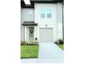 Charming two-story home with a well-manicured lawn at 665 Longboat Dr, Davenport, FL 33896