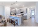 Modern kitchen with a large island, gray cabinets, and stainless steel appliances at 665 Longboat Dr, Davenport, FL 33896