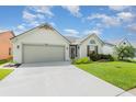 Inviting single-story home featuring a well-kept lawn and an attached two-car garage at 685 Middlebury Loop, New Smyrna Beach, FL 32168