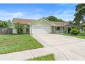 Well-maintained one-story home with a two car garage and a spacious driveway and walkway at 6906 Sawmill Blvd, Ocoee, FL 34761