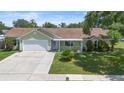 Charming one-story home with well-maintained lawn and landscaping on a bright sunny day at 6906 Sawmill Blvd, Ocoee, FL 34761