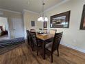 Dining room with wood table and chairs, hardwood floors and decorative wall art at 8020 Tuscany Way # 6307, Davenport, FL 33896