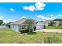 Well-maintained single-story home boasts a lush lawn, screened porch, and attached two-car garage at 804 Glen Creek Ct, Fruitland Park, FL 34731