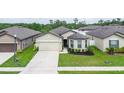 Lovely single-story home with a two-car garage, tidy landscaping, and a welcoming front entrance at 8710 Rindge Rd, Polk City, FL 33868