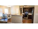 Open concept kitchen showcasing stainless steel appliances, ample counter space, and eat in kitchen table at 8767 Grandee Dr, Orlando, FL 32829