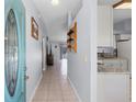 Bright entryway featuring tiled floors, fresh blue walls, and an open view to the kitchen and living areas at 891 Licaria Dr, Ocoee, FL 34761