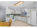 Well-lit kitchen featuring white cabinets, granite countertops, and modern appliances at 891 Licaria Dr, Ocoee, FL 34761