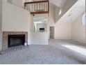 Bright living room featuring a fireplace, high ceilings, and an open layout to the kitchen at 947 Bird Bay Ct # 205, Lake Mary, FL 32746