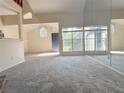 Sunlit living room with large windows, a blue front door, and a full mirrored wall at 947 Bird Bay Ct # 205, Lake Mary, FL 32746