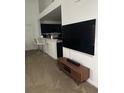 View of the living room featuring a wall mounted TV and modern TV stand at 970 N Spring Garden Ave # 621, Deland, FL 32720