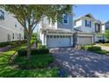 Beautiful townhome with a two-car garage, brick paved driveway, and manicured landscaping at 978 E 10Th St, Apopka, FL 32703