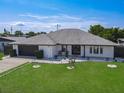 Single story home with an expansive front lawn, lovely rock border, and a path to the covered entrance at 1129 Madura Dr, Deltona, FL 32725