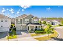 An aerial view shows this corner lot, two-story home, and attached two-car garage in a beautiful neighborhood at 11479 Satire St, Orlando, FL 32832