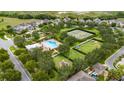 Aerial view of neighborhood amenities featuring a pool, tennis courts, and playground at 15693 Kinnow Mandarin Ln, Winter Garden, FL 34787