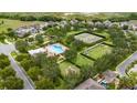 Aerial view of community amenities featuring a pool, tennis courts, and playground at 15693 Kinnow Mandarin Ln, Winter Garden, FL 34787