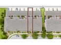Aerial view of townhome with a dark roof outlined in red with a view of the surrounding neighborhood at 15693 Kinnow Mandarin Ln, Winter Garden, FL 34787