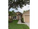 Inviting single-story home with neat landscaping, walkway, and covered entry offers curb appeal at 1639 Corner Meadow Cir, Orlando, FL 32820