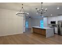 Spacious kitchen with stainless steel appliances, a large island, and modern lighting at 1639 Corner Meadow Cir, Orlando, FL 32820